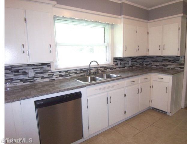 784 Motor Road Winston-Salem, NC 27105 - Photo 6 of 16 Kitchen. Granite countertops and tiled backsplash.
