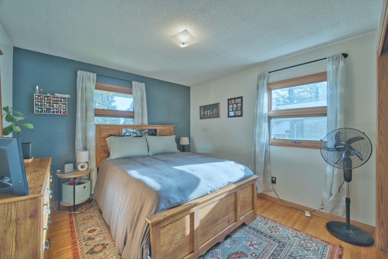 312 South 2nd Street West Aurora, MN 55705 - Photo 13 of 41 Bedroom featuring wood finished floors and a textured ceiling