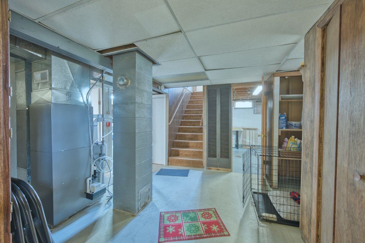 312 South 2nd Street West Aurora, MN 55705 - Photo 19 of 41 Finished basement featuring heating unit and a drop ceiling