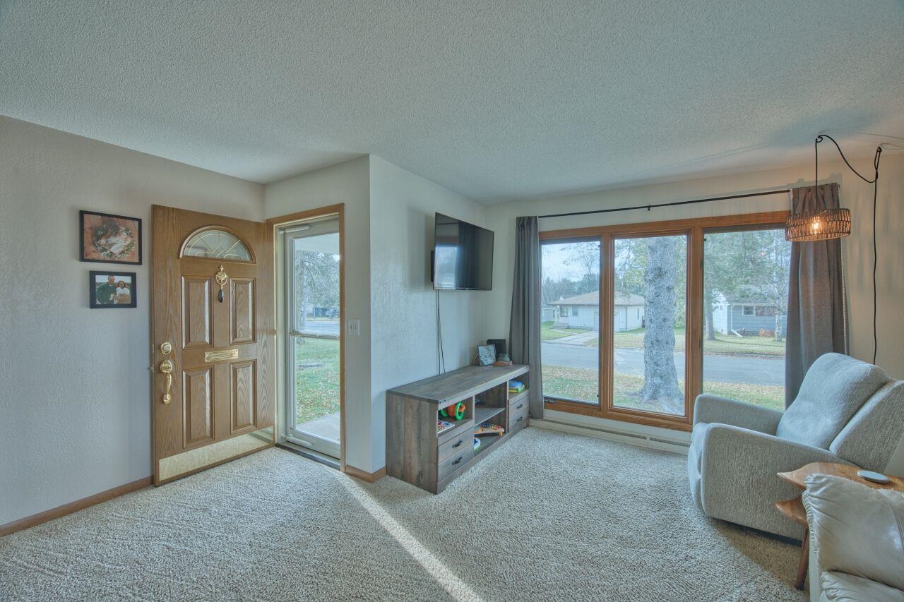 312 South 2nd Street West Aurora, MN 55705 - Photo 2 of 41 Living room with a textured ceiling, carpet floors, and a textured wall