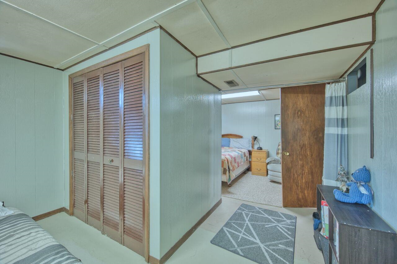 312 South 2nd Street West Aurora, MN 55705 - Photo 21 of 41 Bedroom featuring a closet and wooden walls