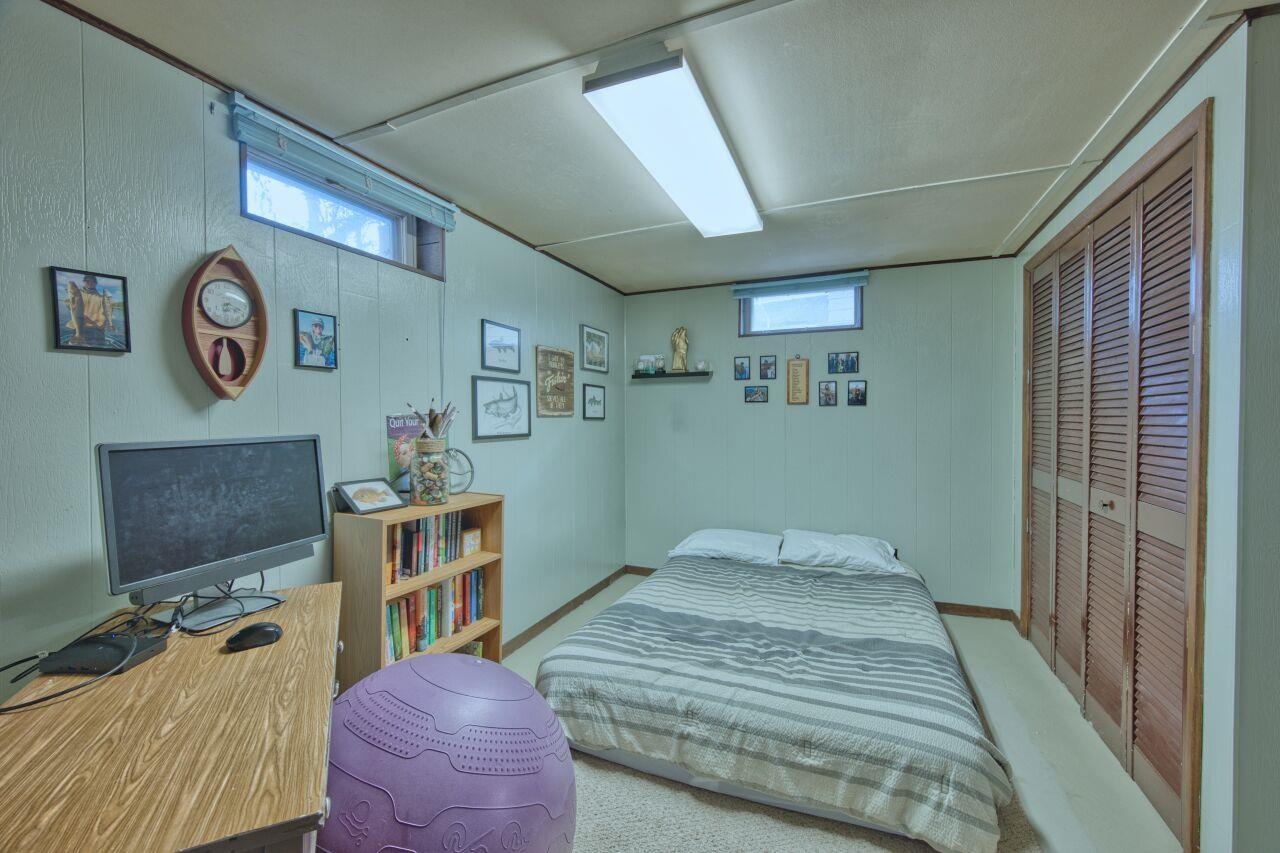 312 South 2nd Street West Aurora, MN 55705 - Photo 23 of 41 Bedroom with a closet, wood walls, and a desk