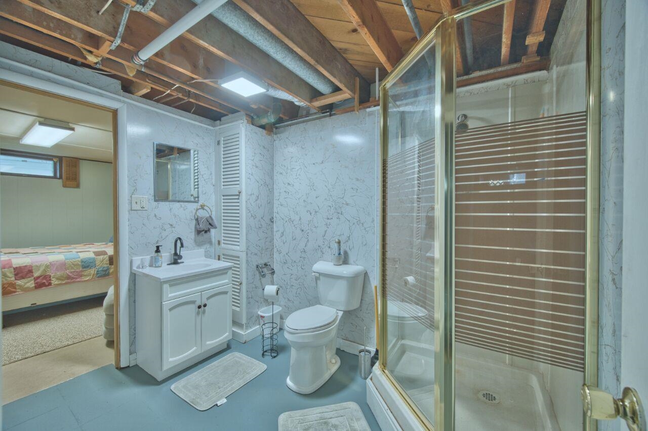 312 South 2nd Street West Aurora, MN 55705 - Photo 24 of 41 Ensuite bathroom with vanity, a shower stall, and finished concrete flooring