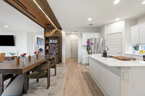 a large kitchen with a table and chairs