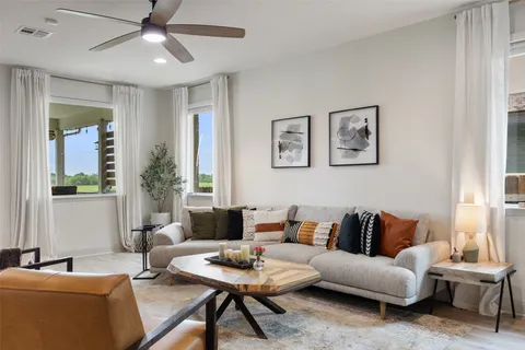 a living room with furniture and a large window