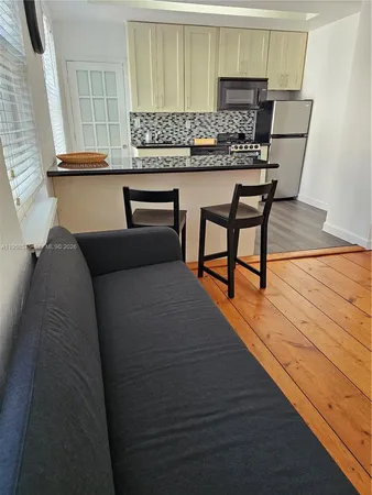 a kitchen with stainless steel appliances kitchen island granite countertop wooden cabinets and a granite counter tops