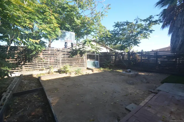 a view of a backyard with a large tree
