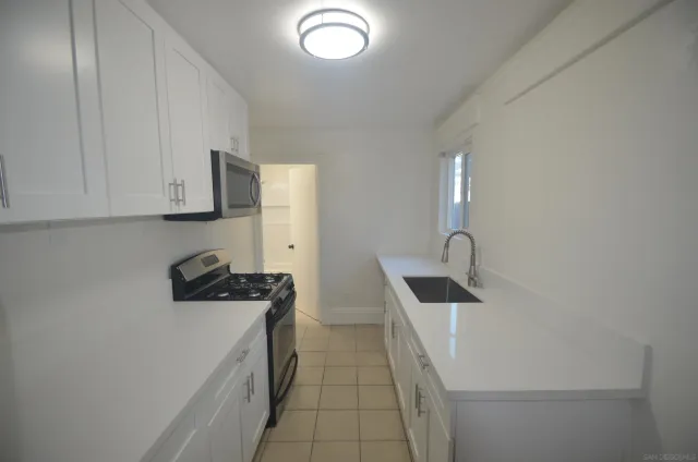 a kitchen with a sink and cabinets