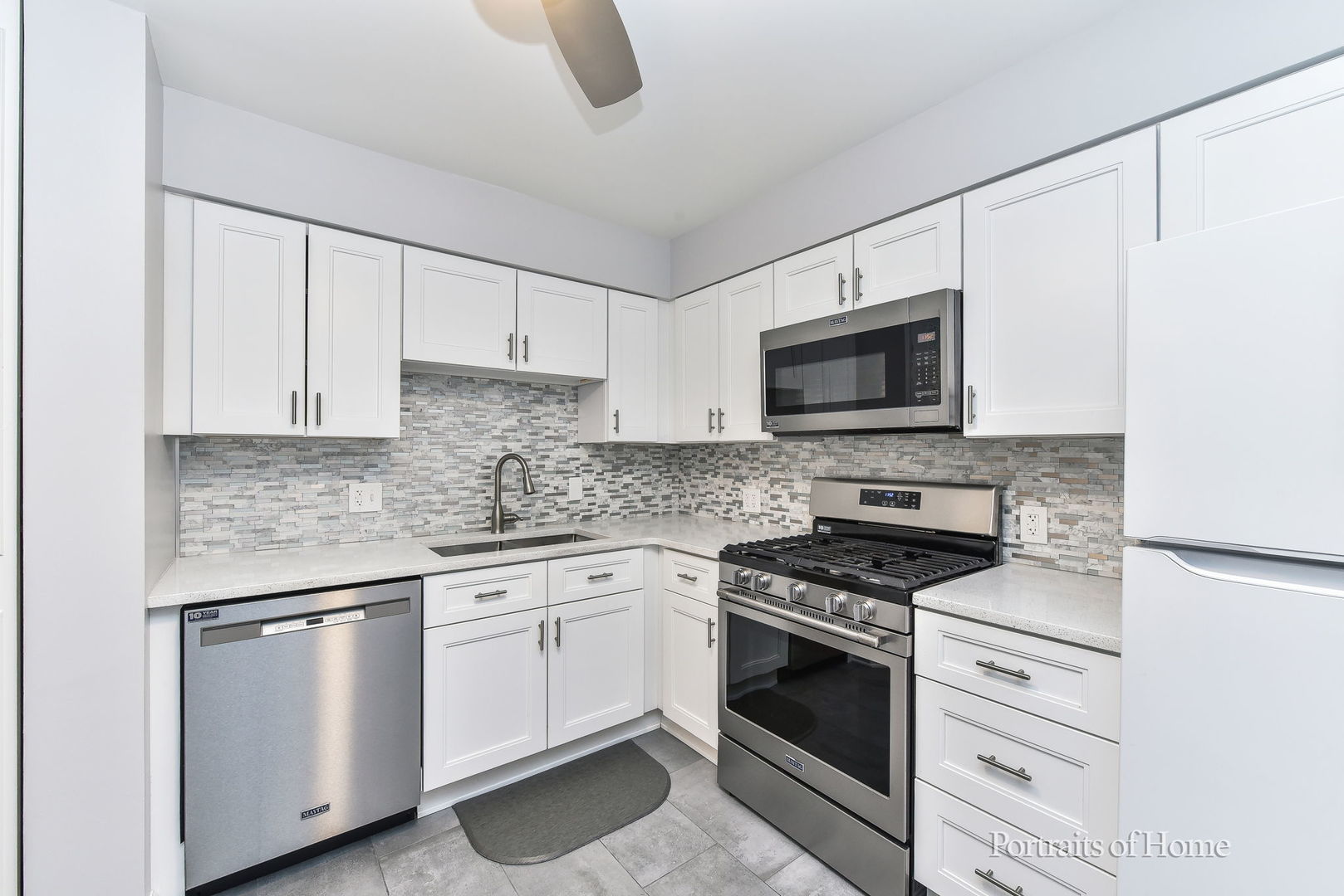 6630 South Brainard Avenue, Unit 203 Countryside, IL 60525 - Photo 9 of 22 a kitchen with white cabinets stainless steel appliances and sink