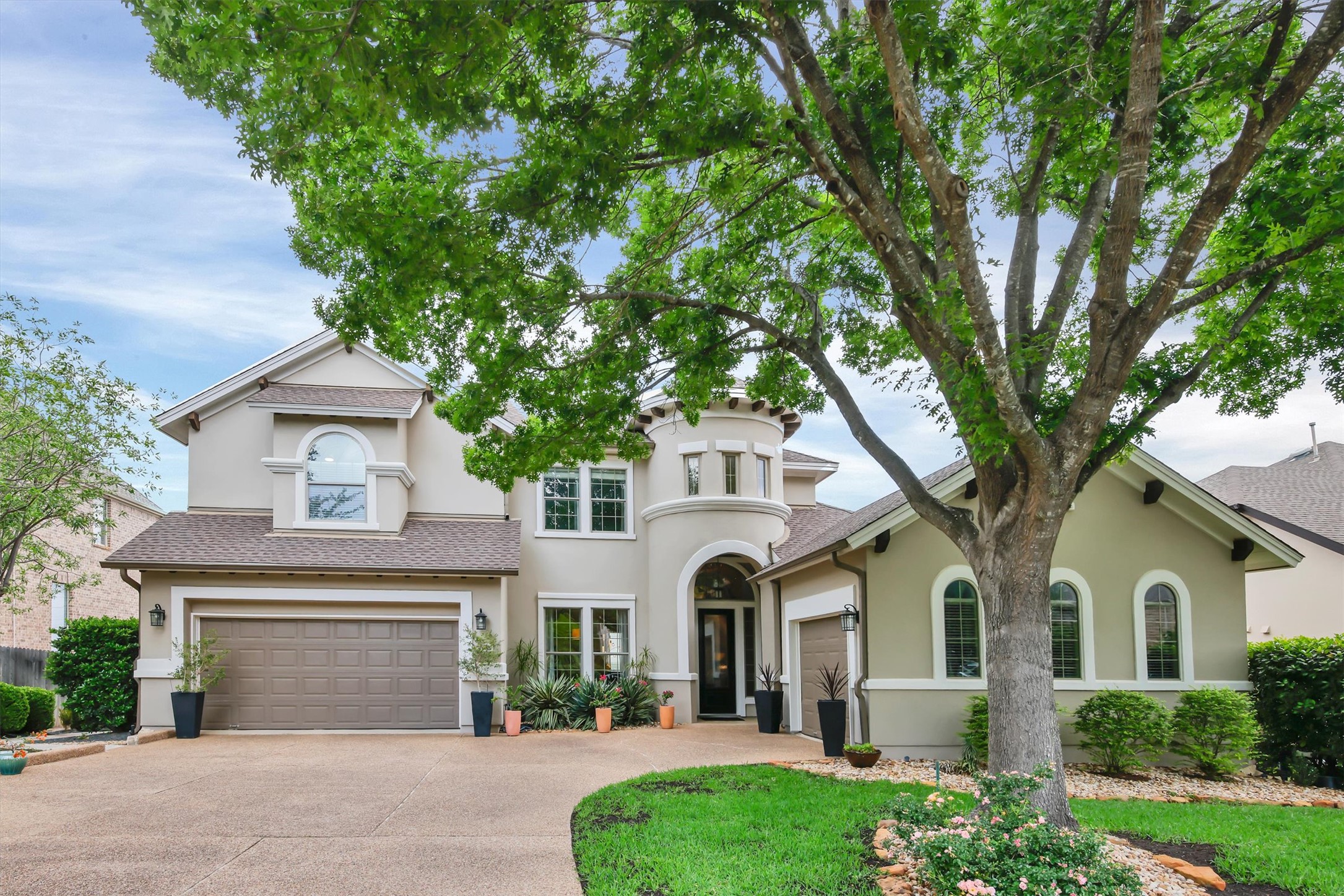 The property features a stucco exterior, an arched entryway, and multiple arched windows
