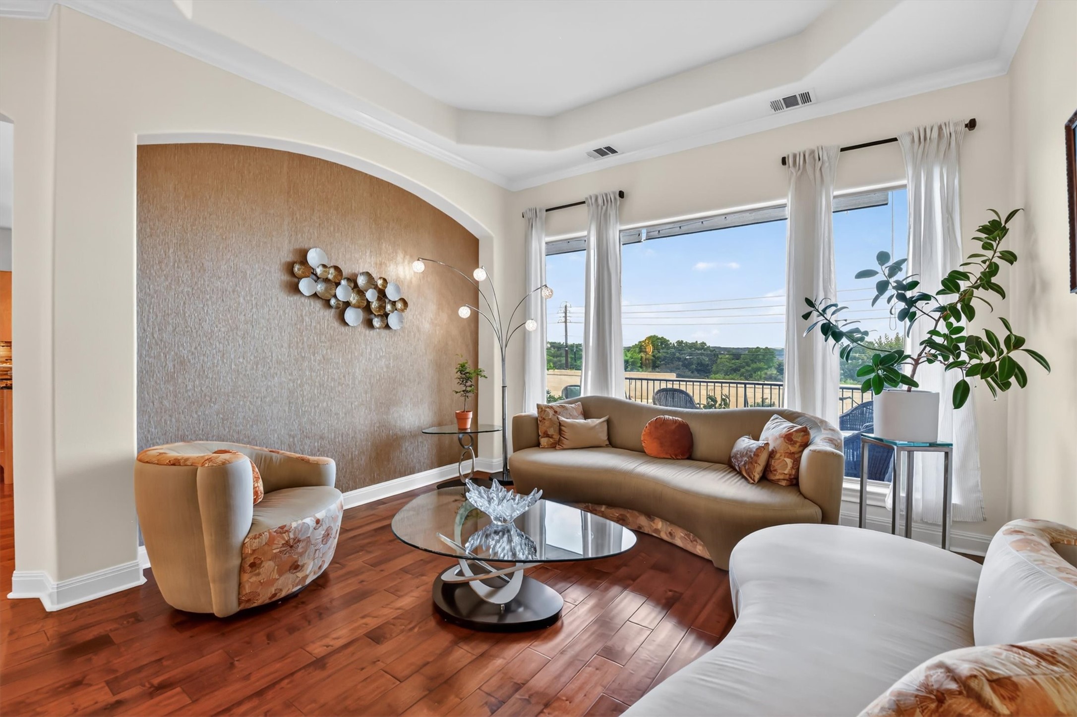 2000 Rio Mesa Drive Austin, TX 78732 - Photo 12 of 39 The living area features hardwood floors and a tray ceiling, with large windows providing expansive views of the outdoors