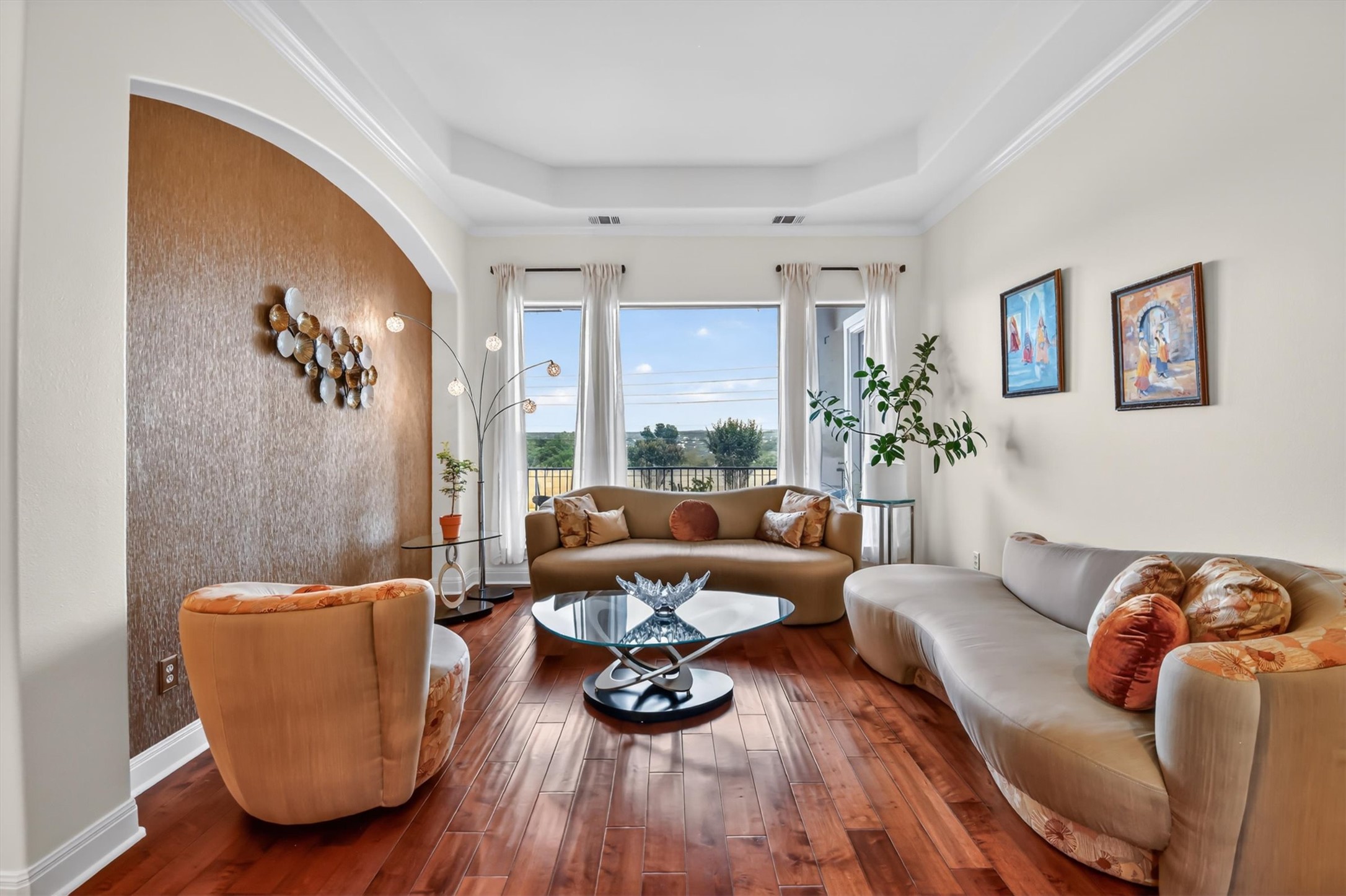 2000 Rio Mesa Drive Austin, TX 78732 - Photo 13 of 39 The living space features hardwood floors, a tray ceiling, and a wall with textured wallpaper