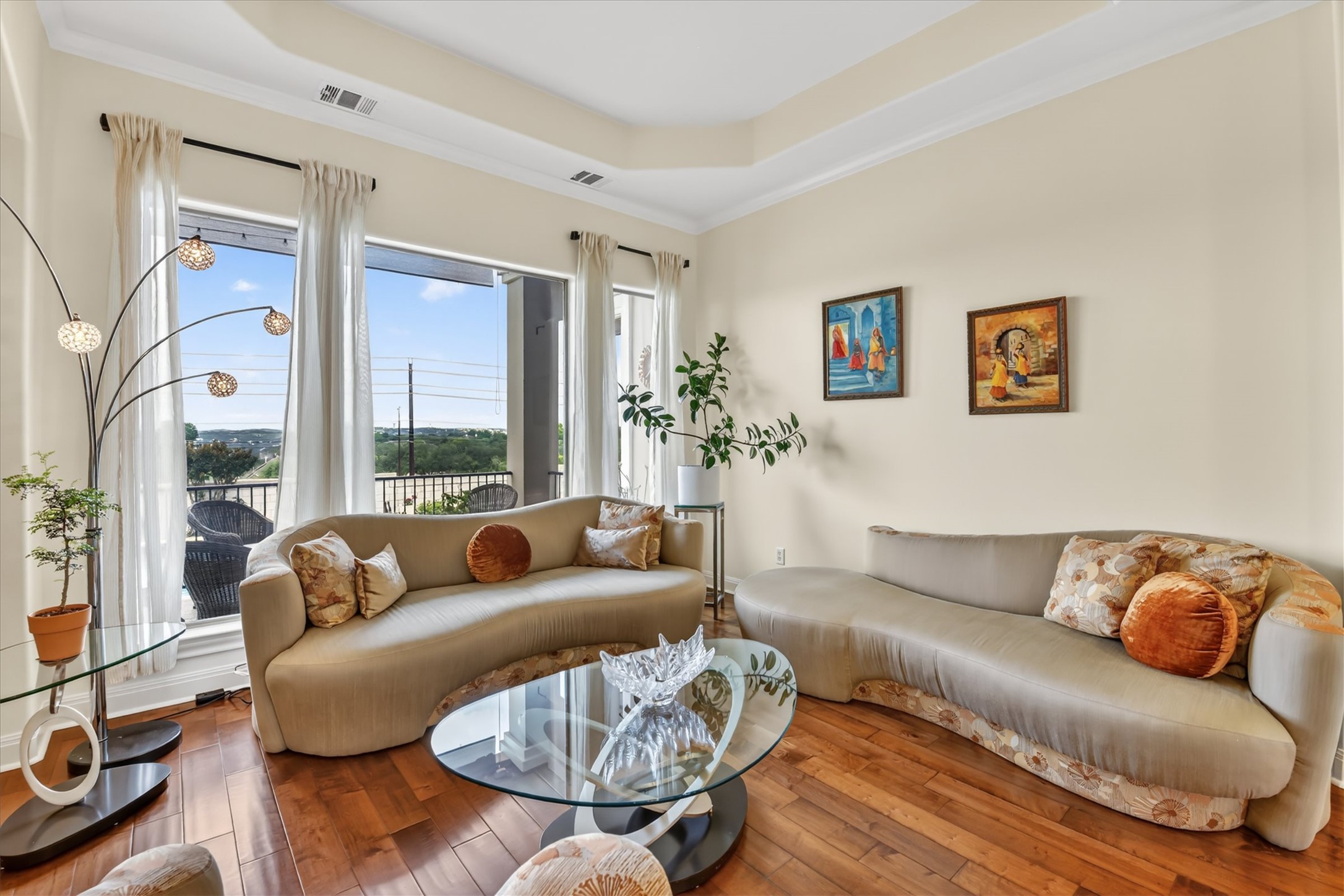 2000 Rio Mesa Drive Austin, TX 78732 - Photo 14 of 39 Living area featuring hardwood floors, a tray ceiling, and large windows with a view