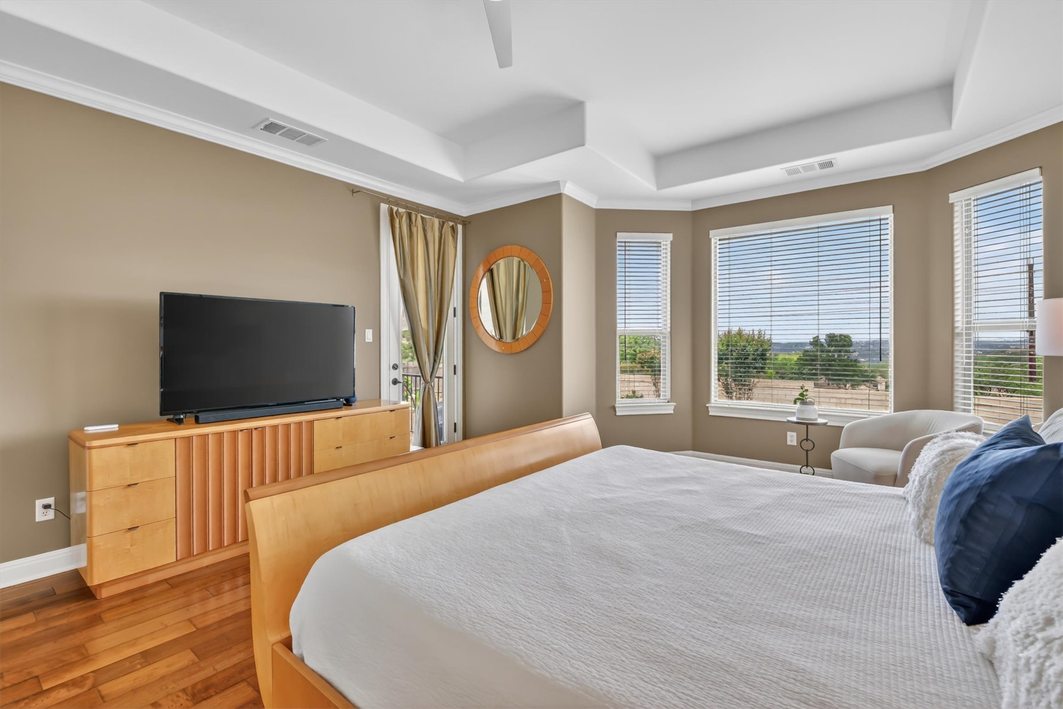 2000 Rio Mesa Drive Austin, TX 78732 - Photo 21 of 39 This bright bedroom features hardwood flooring, a tray ceiling, and a bay window providing expansive views of the surrounding landscape
