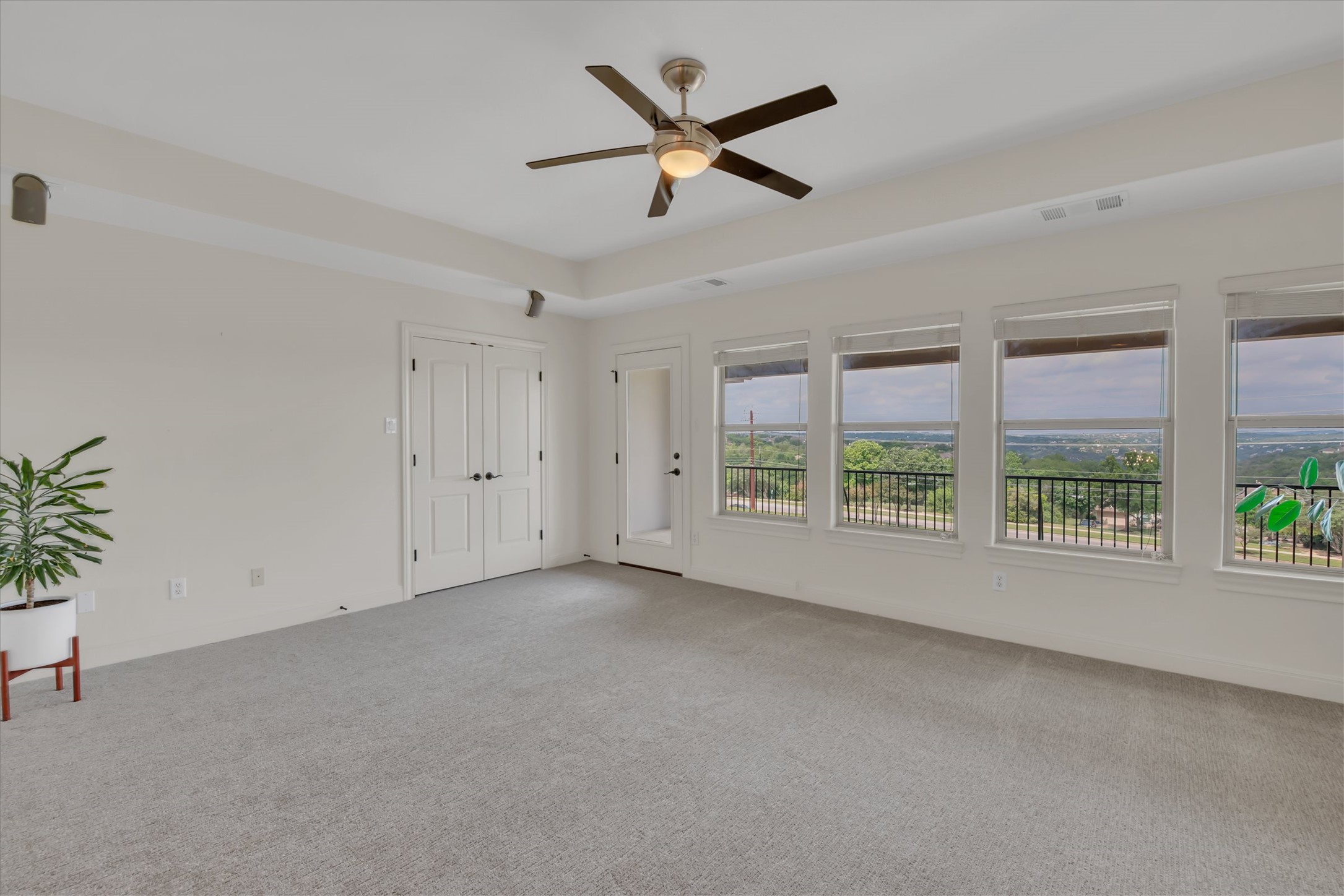 2000 Rio Mesa Drive Austin, TX 78732 - Photo 26 of 39 This spacious room features light-colored carpeting, a ceiling fan, and extensive windows that provide views of the surrounding landscape