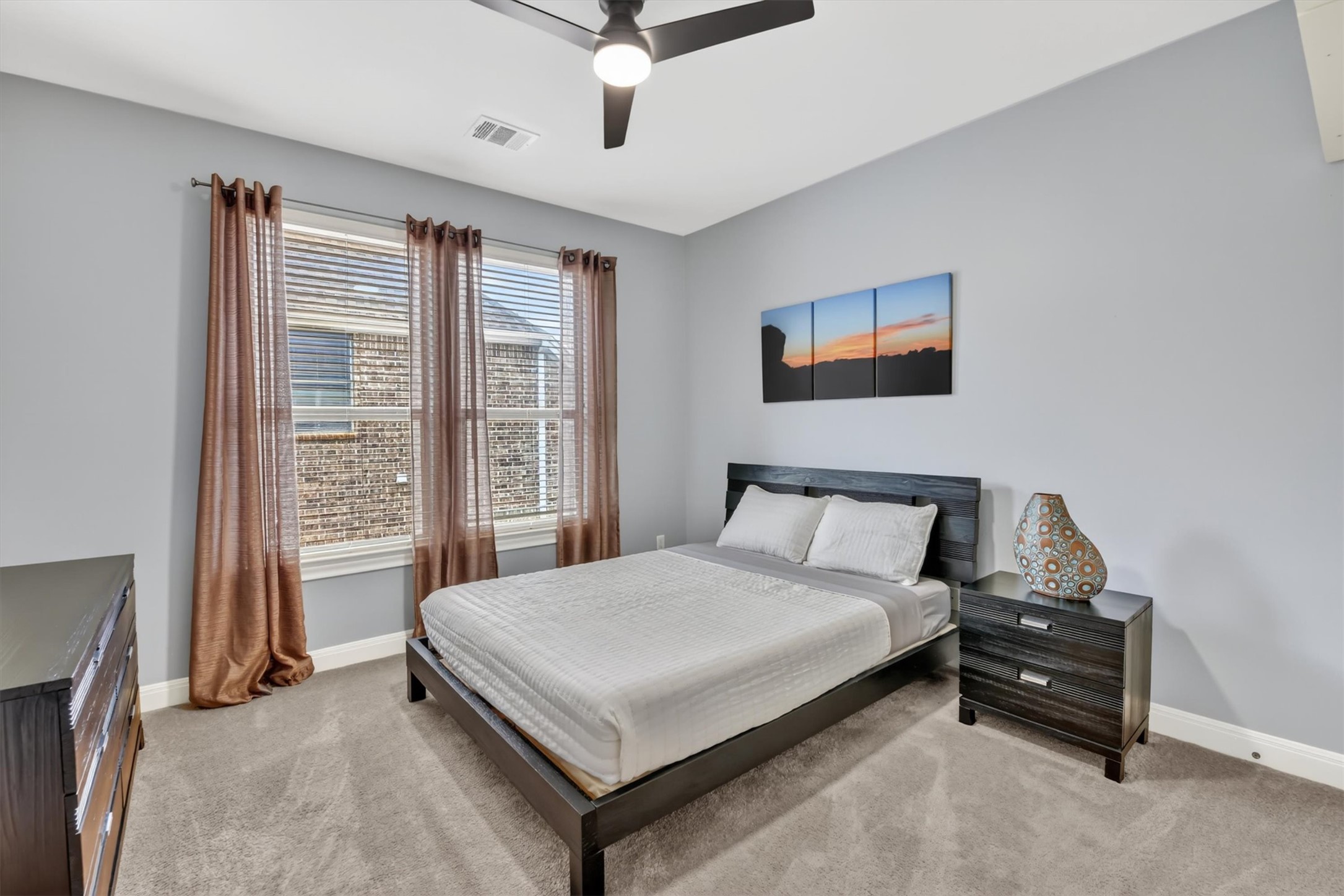 2000 Rio Mesa Drive Austin, TX 78732 - Photo 30 of 39 This room features neutral-toned walls and carpet, a ceiling fan, and a window with blinds and curtains