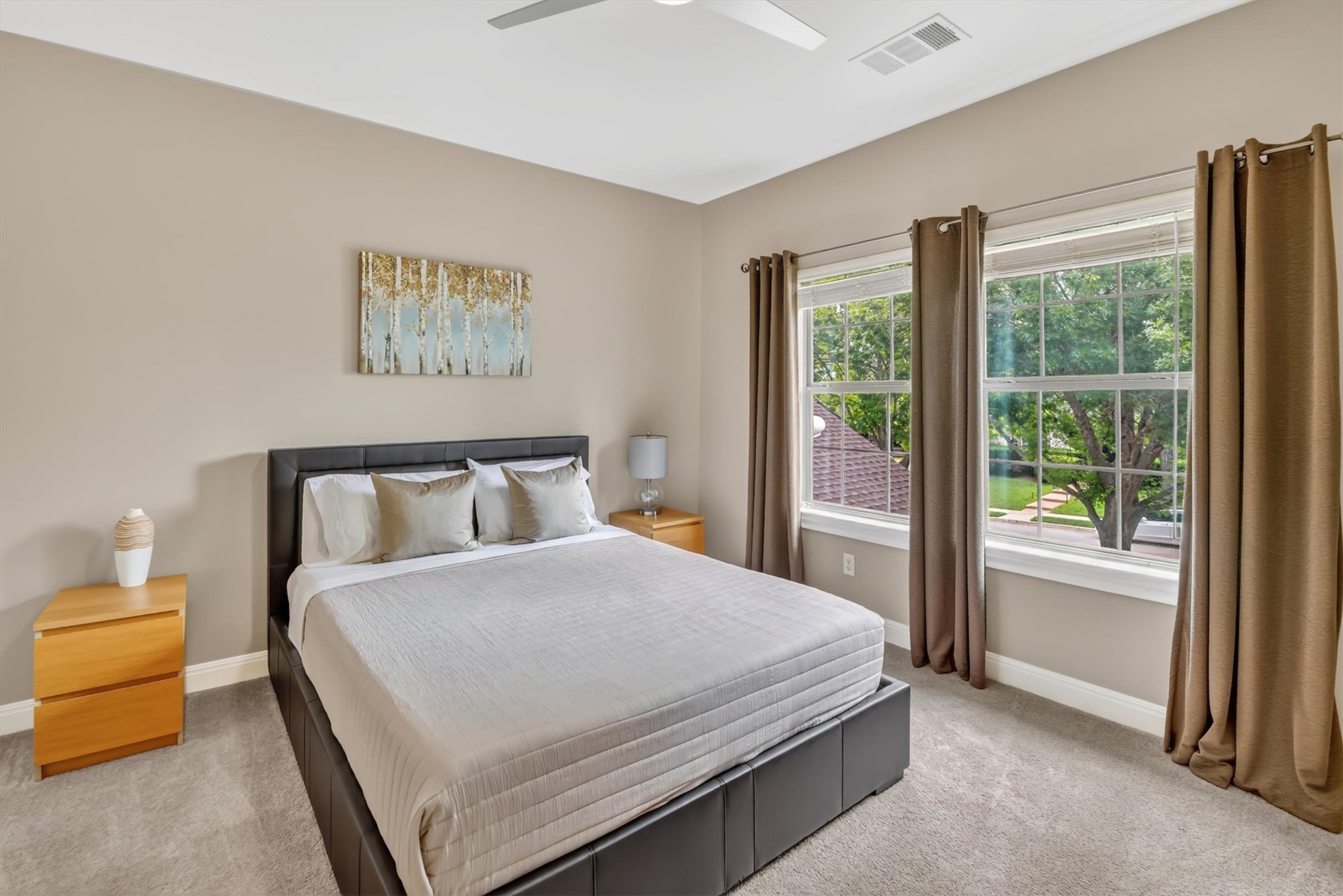 2000 Rio Mesa Drive Austin, TX 78732 - Photo 34 of 39 This bedroom features light-colored walls, carpeted flooring, and two large windows with views of greenery
