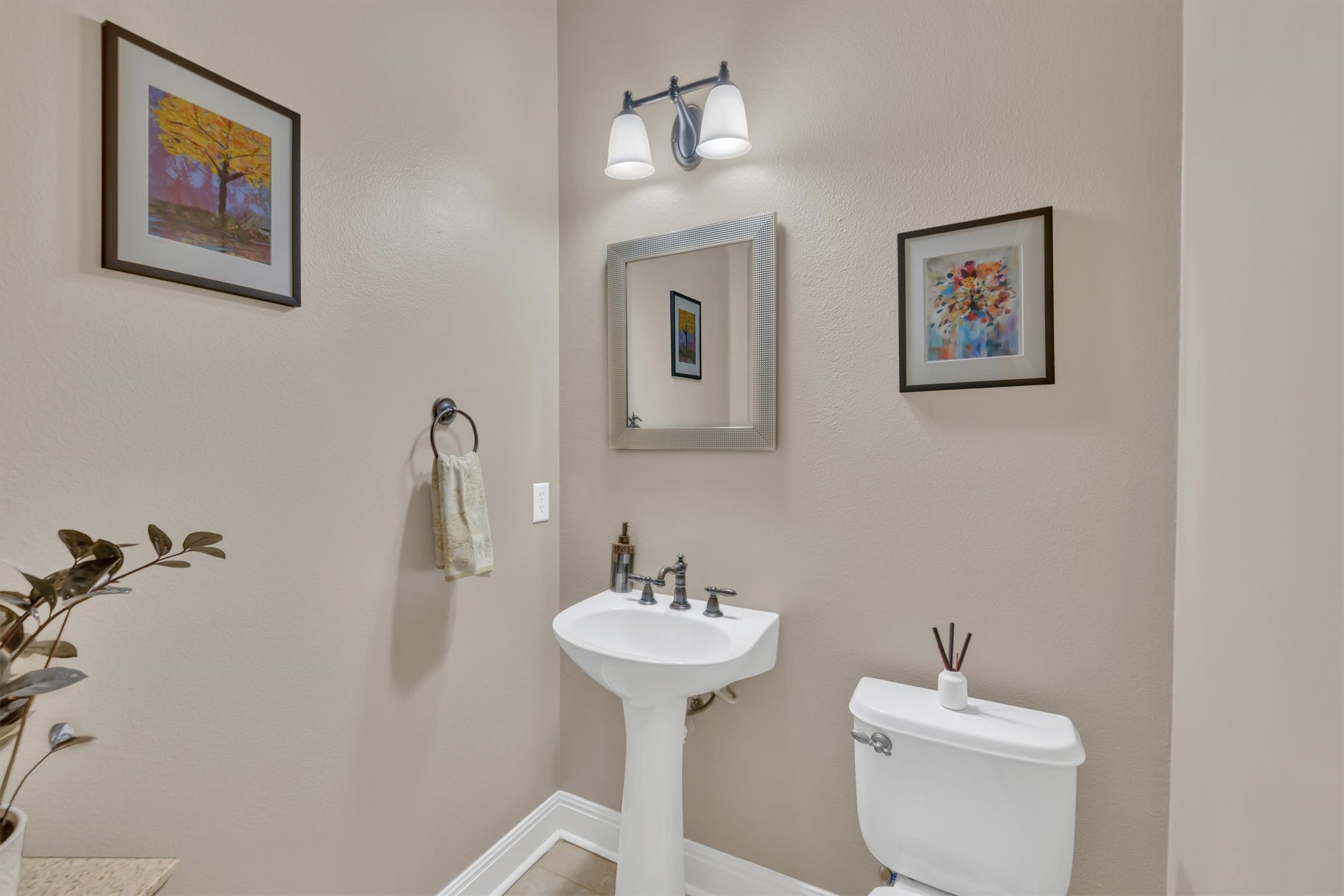 2000 Rio Mesa Drive Austin, TX 78732 - Photo 35 of 39 This bathroom features a pedestal sink with a mirror and a wall-mounted light fixture