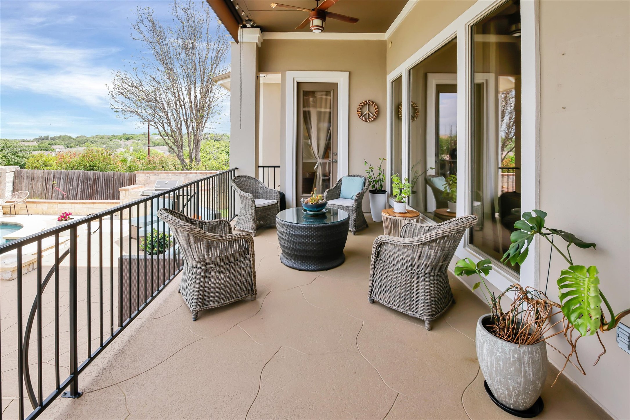 2000 Rio Mesa Drive Austin, TX 78732 - Photo 36 of 39 Expansive covered patio featuring a ceiling fan, recessed lighting, and a black metal railing overlooking a pool