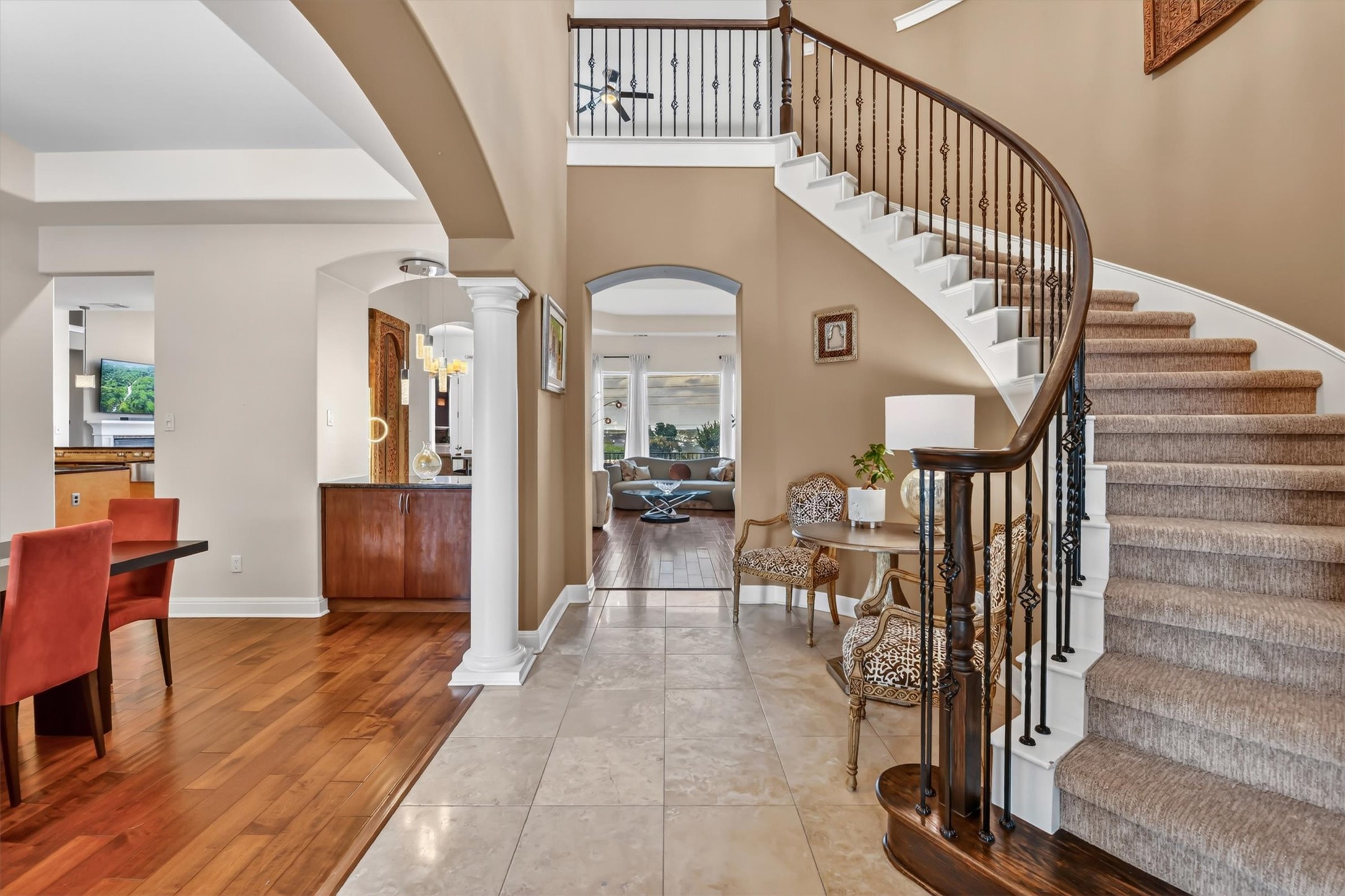 2000 Rio Mesa Drive Austin, TX 78732 - Photo 5 of 39 Grand foyer featuring a curved staircase with carpeted treads and wrought iron balusters