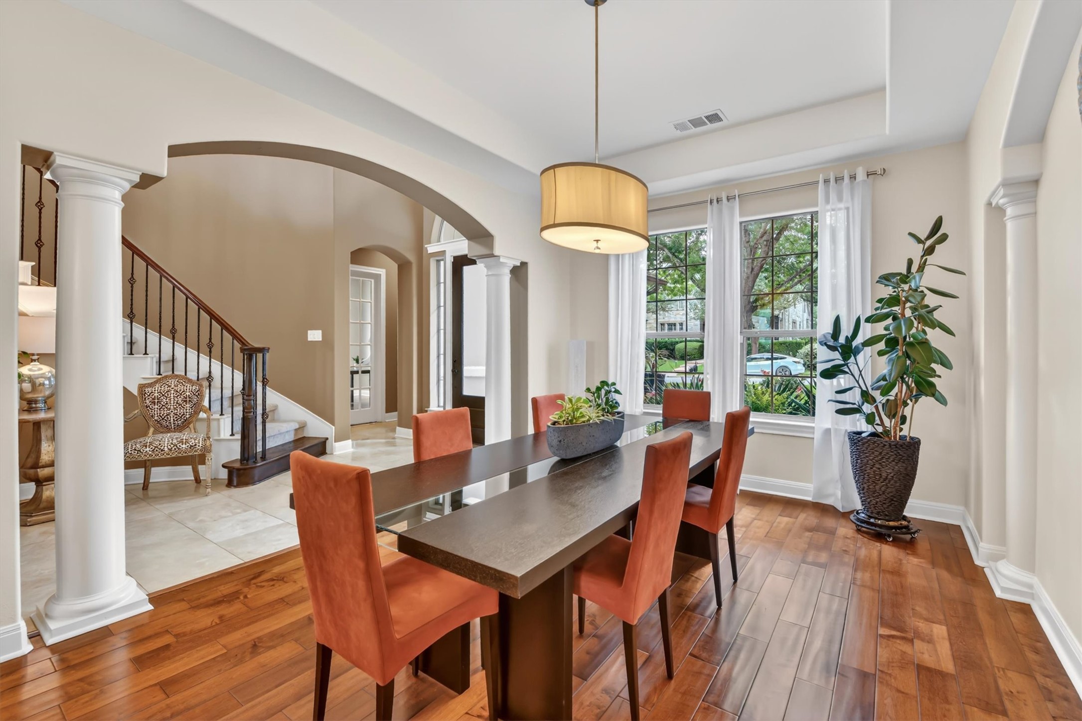 2000 Rio Mesa Drive Austin, TX 78732 - Photo 10 of 39 Elegant room with hardwood floors, large windows, and a decorative arched entryway