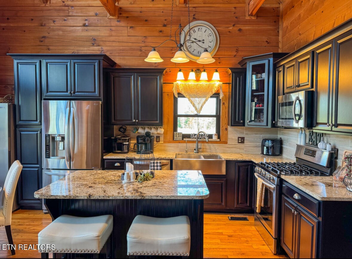 390 John J Smith Road Oneida, TN 37841 - Photo 15 of 56 a kitchen with a table chairs stove and refrigerator