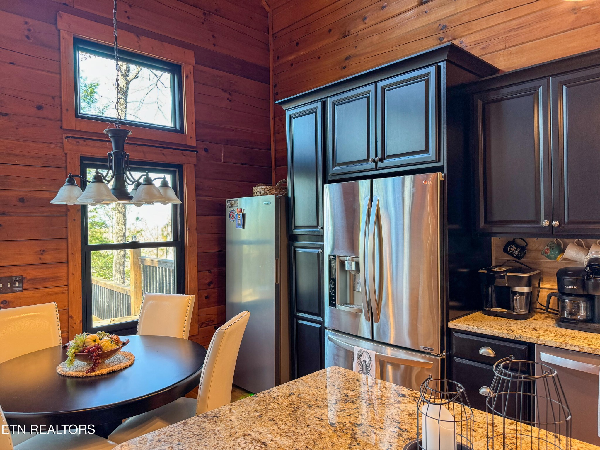390 John J Smith Road Oneida, TN 37841 - Photo 16 of 56 a kitchen with stainless steel appliances kitchen island granite countertop a refrigerator a stove a sink dishwasher with a dining table and chairs