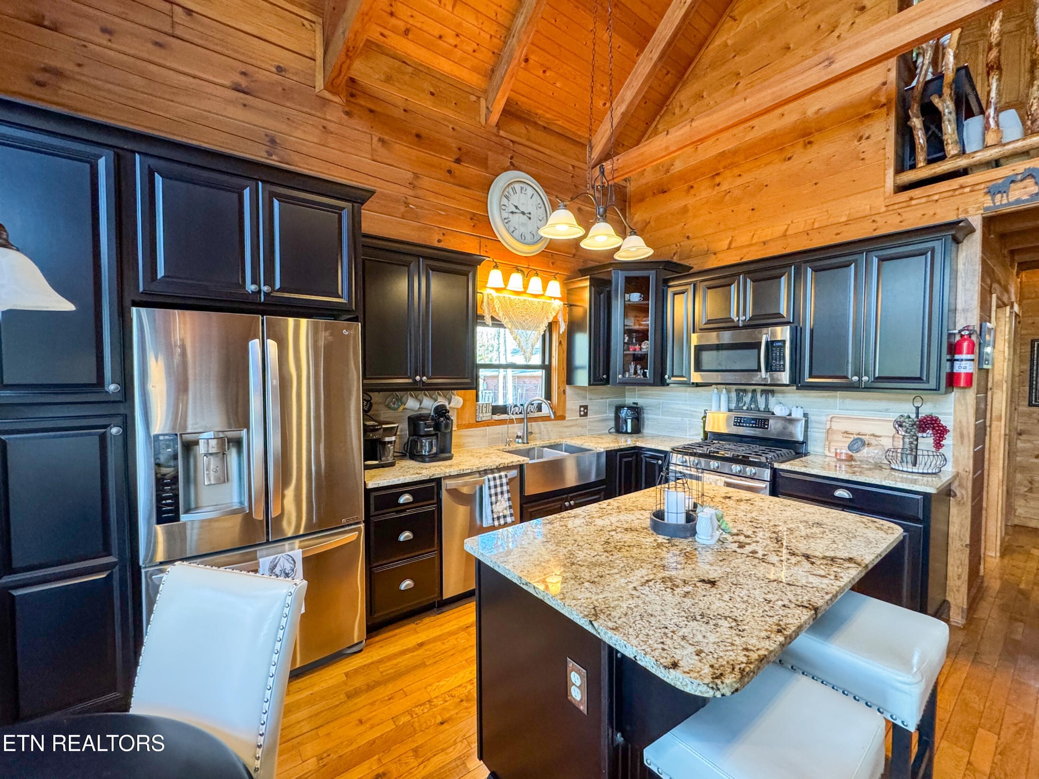 390 John J Smith Road Oneida, TN 37841 - Photo 17 of 56 a kitchen with stainless steel appliances granite countertop a sink refrigerator and cabinets