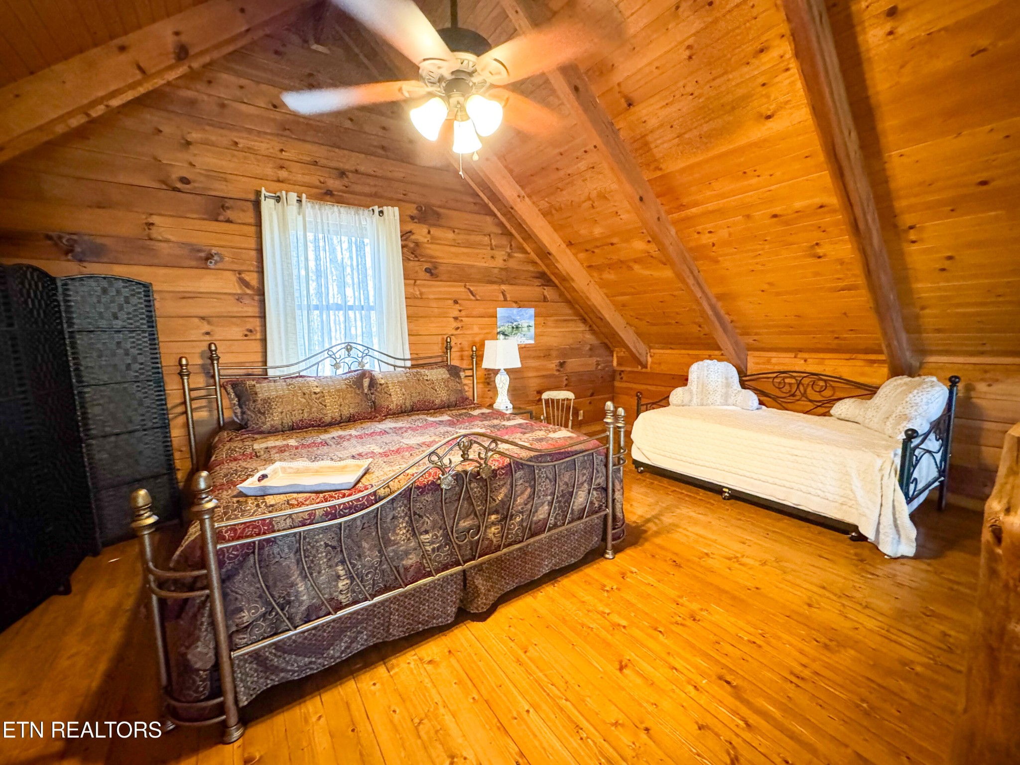 390 John J Smith Road Oneida, TN 37841 - Photo 27 of 56 a bedroom with a bed and wooden floor