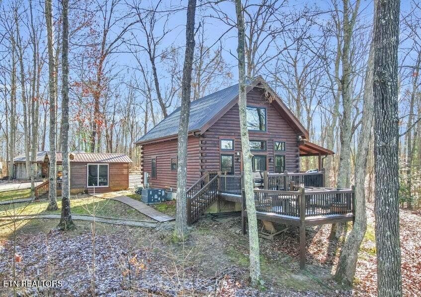 390 John J Smith Road Oneida, TN 37841 - Photo 3 of 56 a backyard of a house with barbeque oven