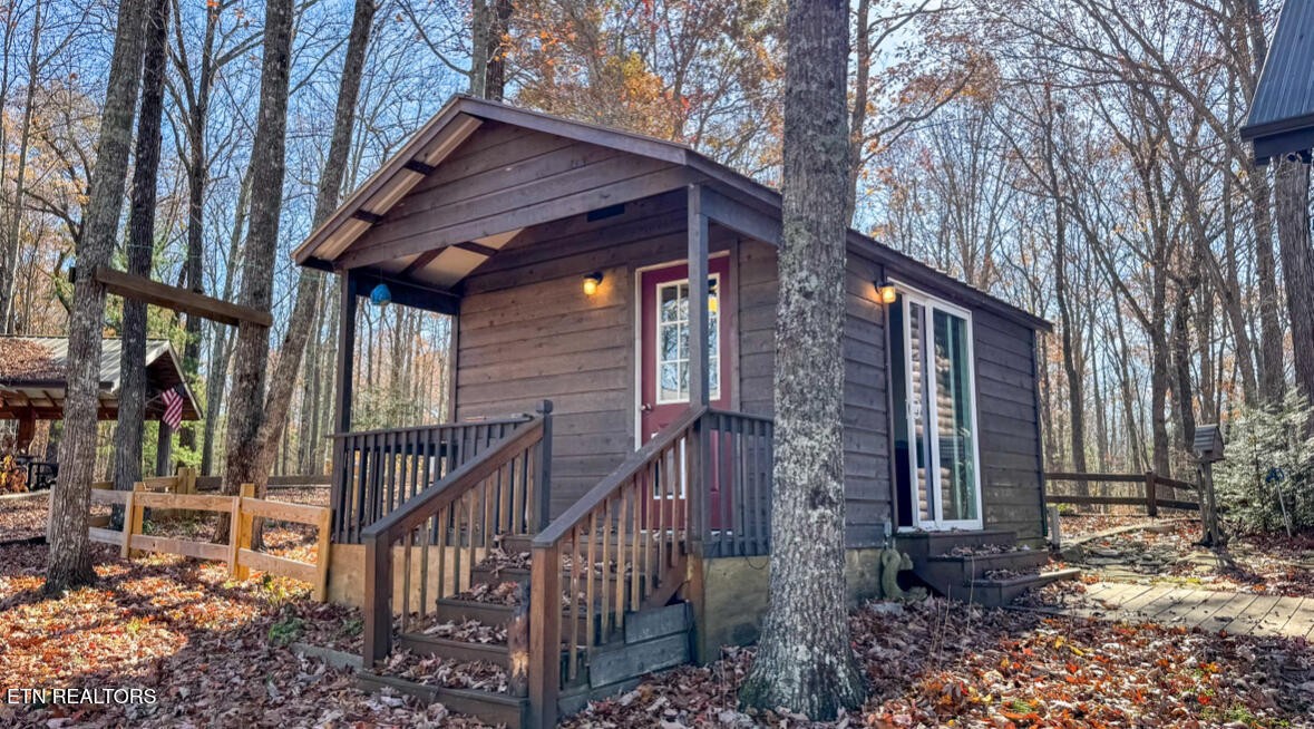 390 John J Smith Road Oneida, TN 37841 - Photo 38 of 56 a view of a house with wooden fence and two windows
