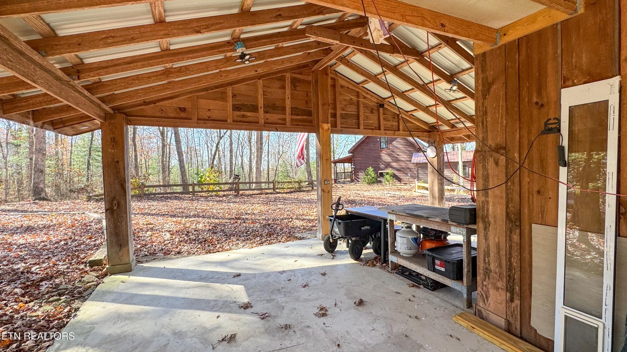 390 John J Smith Road Oneida, TN 37841 - Photo 44 of 56 a backyard of a house with a large tree and wooden fence