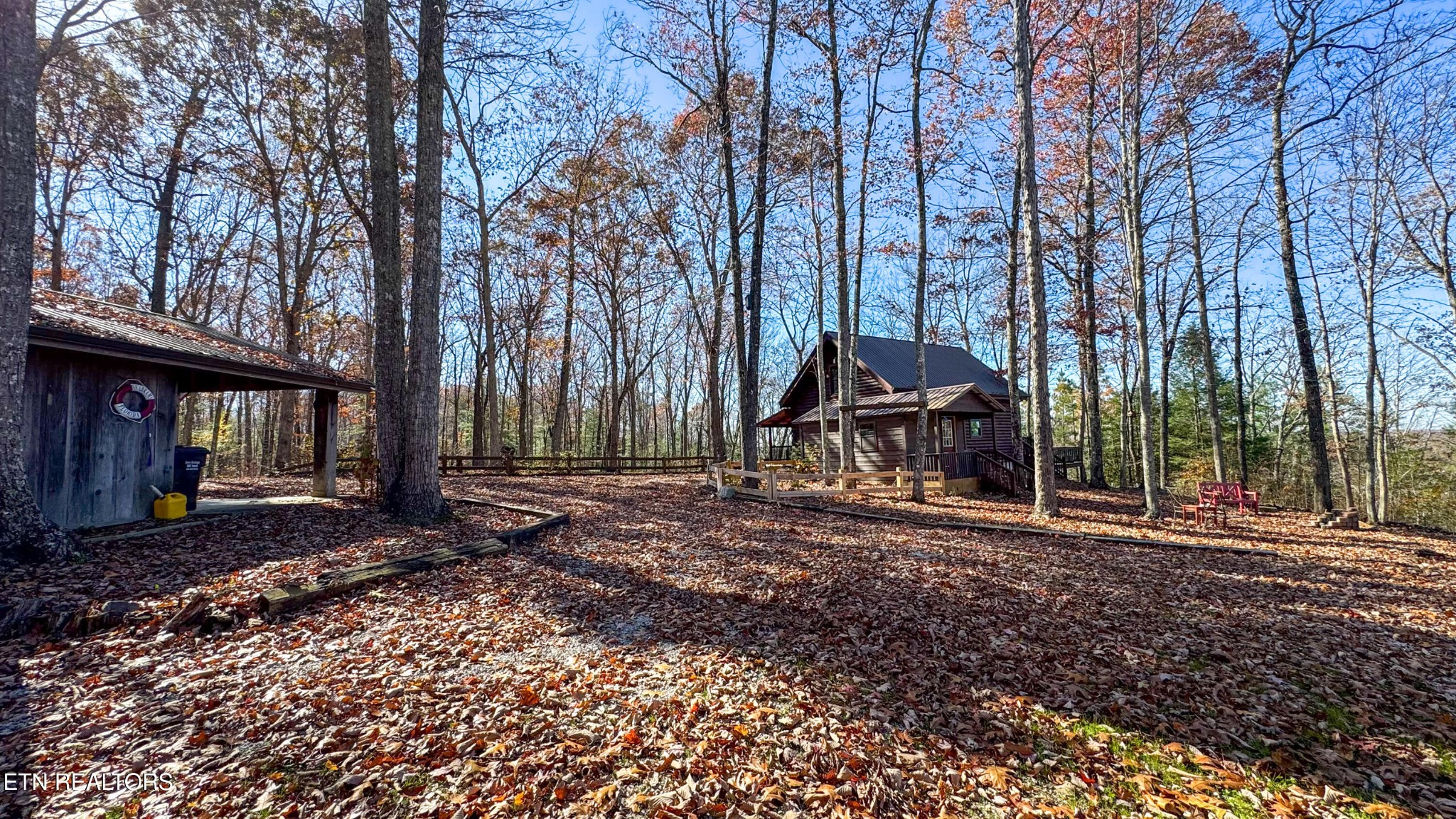 390 John J Smith Road Oneida, TN 37841 - Photo 54 of 56 a backyard of a house with barbeque oven table and chairs