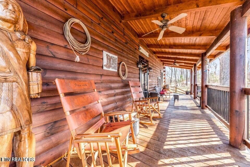 390 John J Smith Road Oneida, TN 37841 - Photo 9 of 56 a view of a patio with table and chairs with wooden floor and fence
