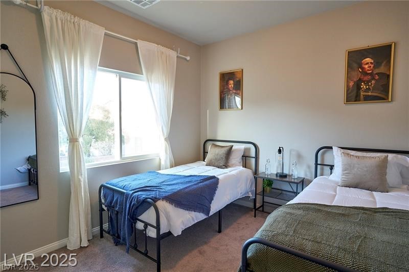 6302 Jackson Spring Road Las Vegas, NV 89118 - Photo 13 of 23 A well-lit bedroom features plush carpeting and a bright window offering natural illumination.