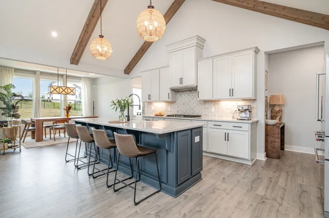 a kitchen with a sink cabinets and wooden floor