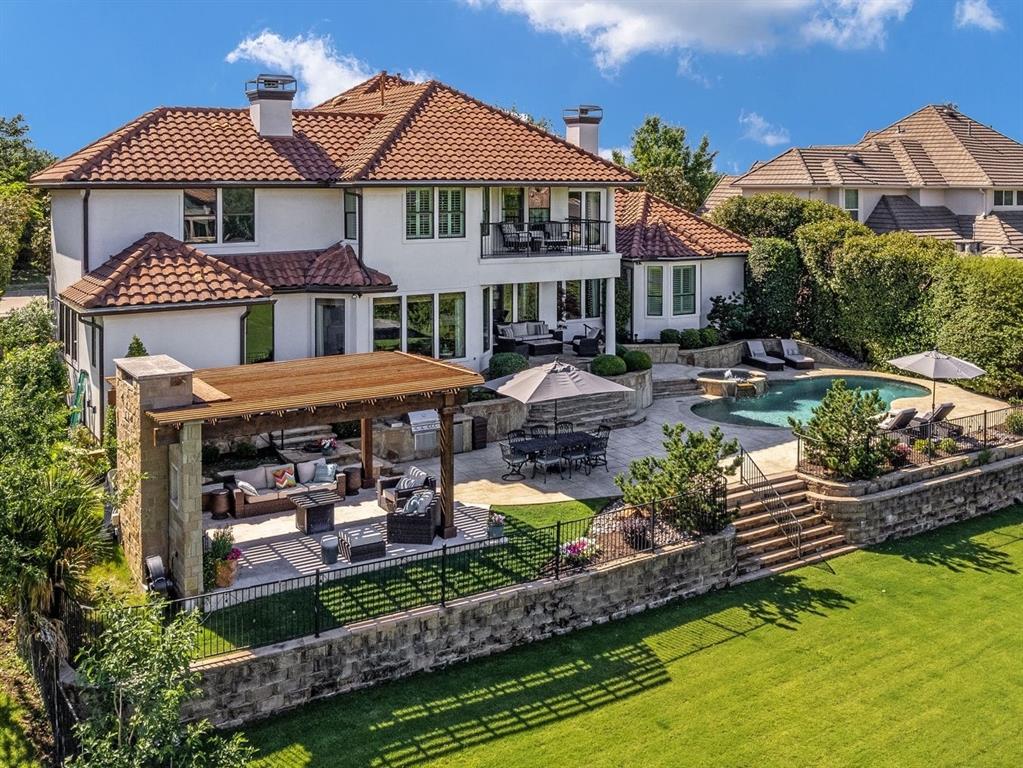 an aerial view of a house with swimming pool a patio and outdoor seating
