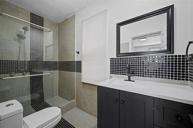 a bathroom with a sink toilet and shower