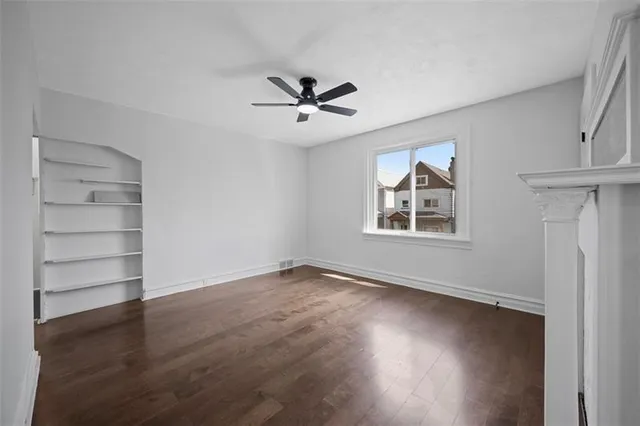 wooden floor in an empty room with a window