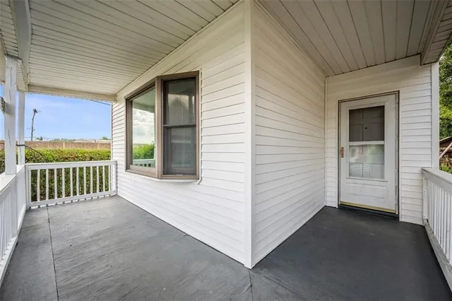 a view of a porch with wooden floor and fence