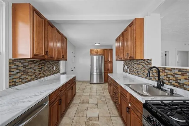 a kitchen with granite countertop a sink and a stove