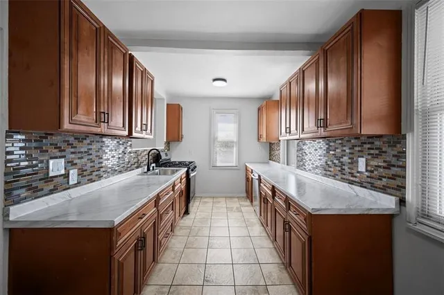 a kitchen with stainless steel appliances granite countertop a sink stove and cabinets