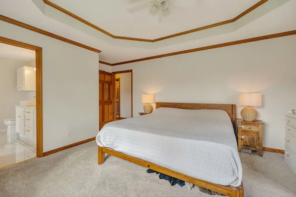 a bedroom with a bed and lamp