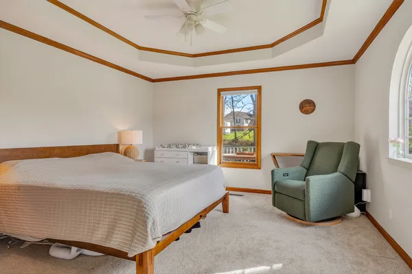 a bedroom with a bed and a chandelier