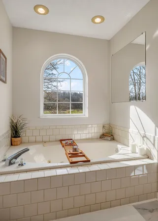 a bath tub sitting next to a window