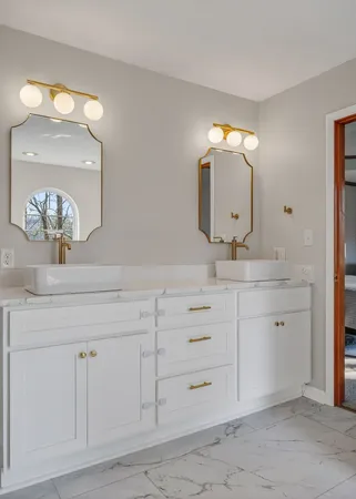 a bathroom with a sink vanity and mirror