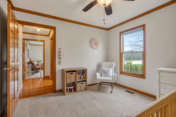 a living room with furniture a ceiling fan and a window