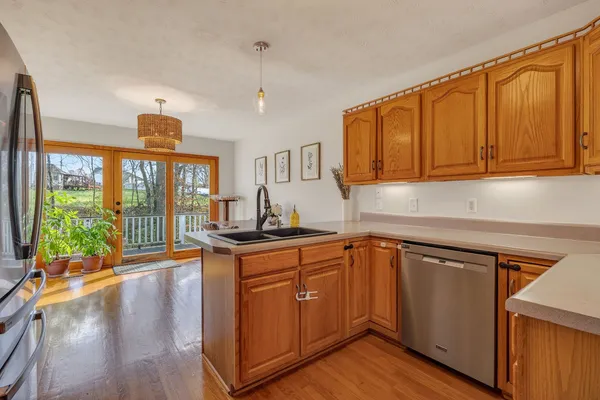 a kitchen with stainless steel appliances granite countertop a stove and a sink