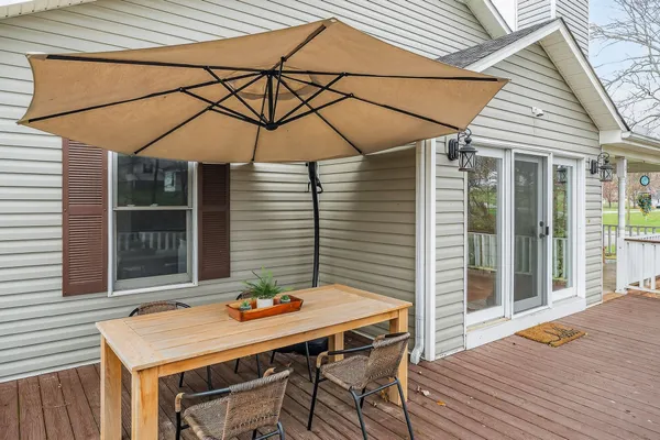 a backyard of a house with table and chairs