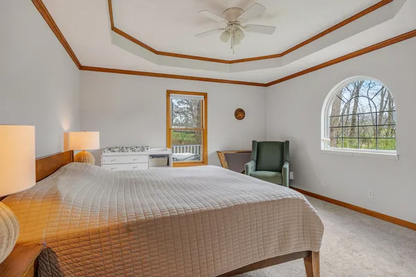 a bedroom with a bed and a chandelier